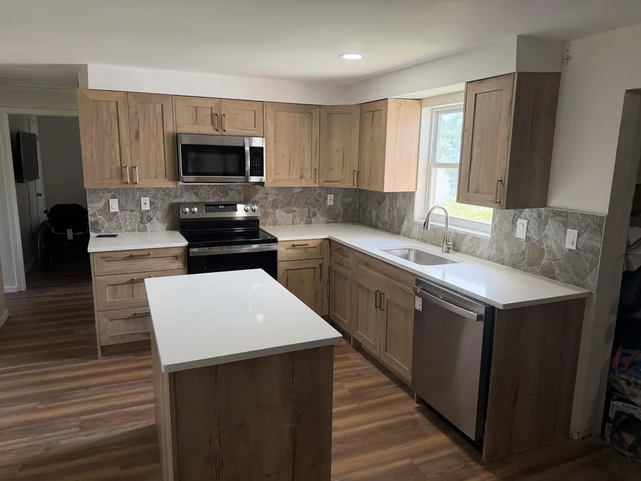 Close-up of tile backsplash coursing set square around an outlet and under the wall cabinets