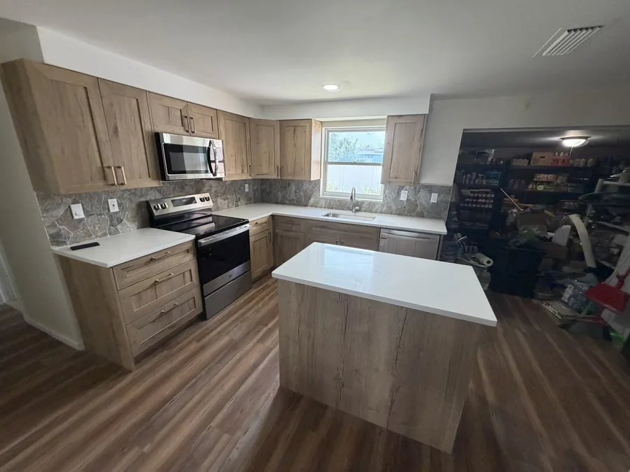 Close-up of refaced cabinet doors and drawer fronts meeting a quartz countertop edge