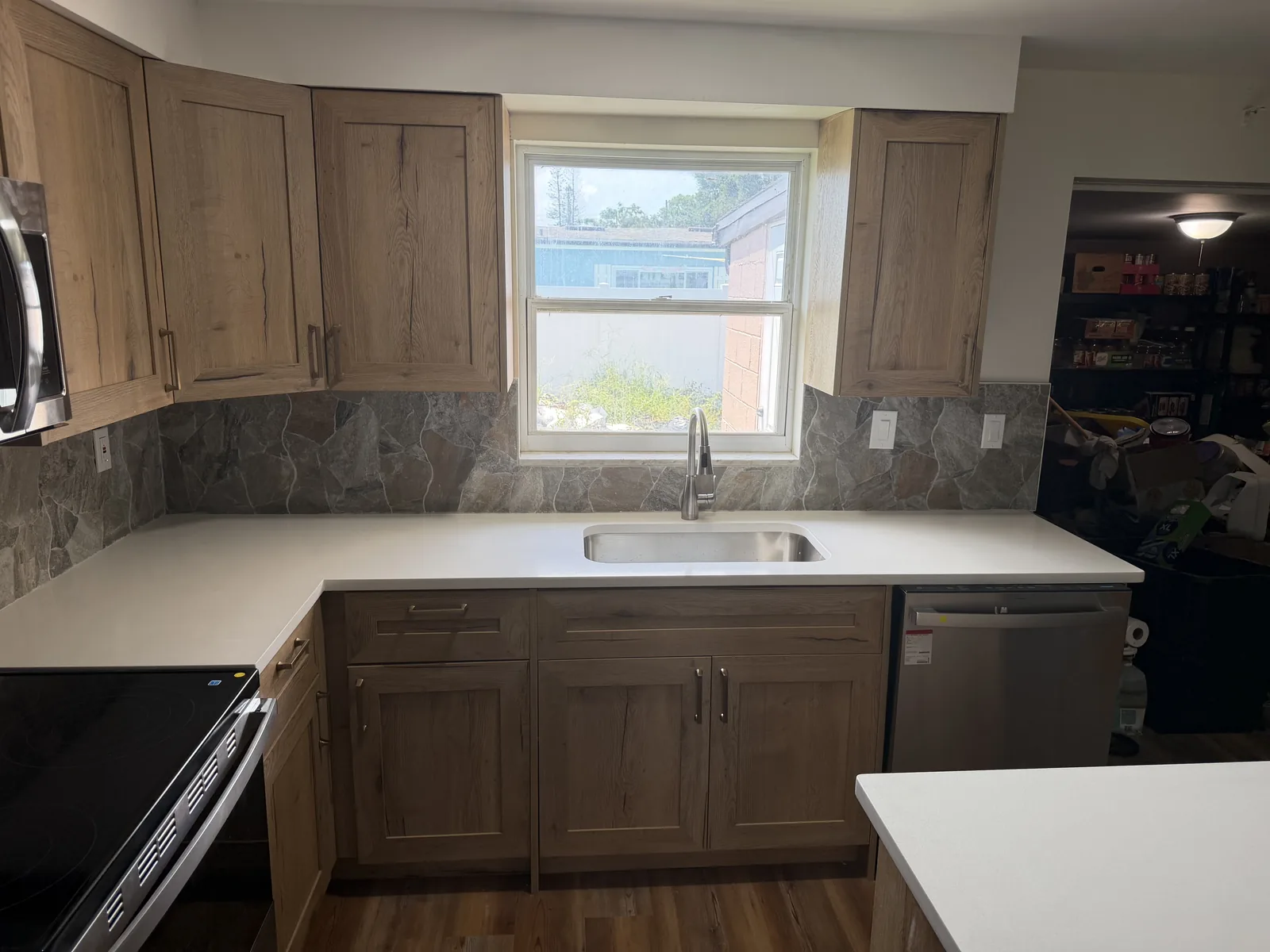 White quartz countertops running the length of a kitchen and across a central island